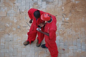 Two workers compare mobile phones